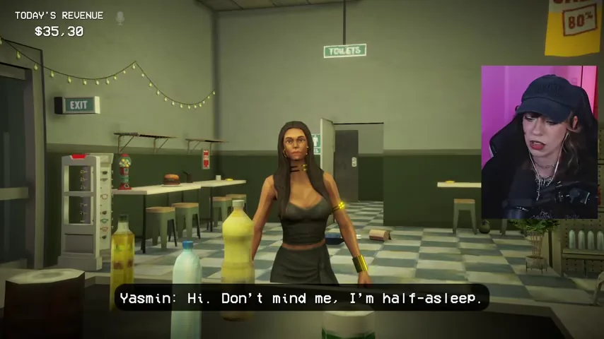Yasmin stands at the counter wearing several visible pieces of gold jewelry.